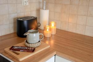 a counter top with a coffee pot on a cutting board at Calm City Studio By BookLapland in Rovaniemi