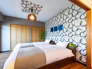 Кровать или кровати в номере MY STORY Familia 801-無料駐車場