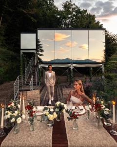 a man and a woman sitting at a table with flowers at Spino Fiorito Stay in Casola in Lunigiana