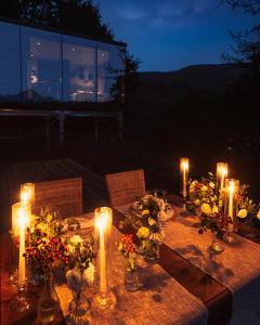a table with candles and flowers on it at Spino Fiorito Stay in Casola in Lunigiana