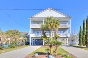 a house with palm trees in front of it at Stairway to Havens - North in Myrtle Beach