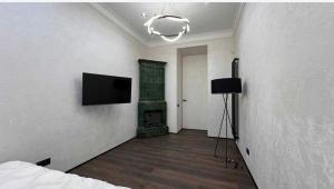 a room with a television on a wall with a fireplace at Rynok Square Pidzemelya in Lviv