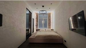 a bedroom with a bed and a window at Rynok Square Pidzemelya in Lviv
