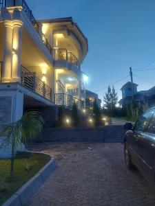 a car parked in front of a house at night at Freeve Suites Akright City Bwebajja in Buzzi