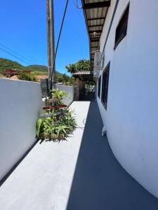 a balcony with plants on the side of a building at Pousada Armação das Baleias in Penha +22 photos