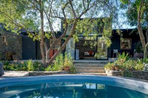 an external view of a house with a swimming pool at Aarde in Barrydale