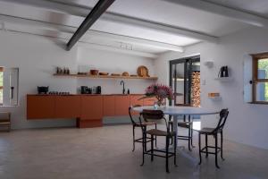 a kitchen with a table and chairs in a room at Aarde in Barrydale +22 photos