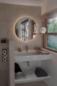 a bathroom with a sink and a mirror at Aarde in Barrydale