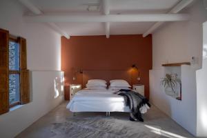 a bedroom with a bed with white sheets and pillows at Aarde in Barrydale