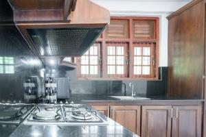 a kitchen with a stove and a counter top at Villa Amora in Patuwata