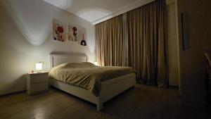 a bedroom with a bed and a window at Bakuriani Cozy Studio in Bakuriani