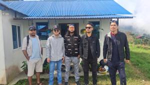 a group of men standing in front of a house at Khasre Gurung Gaun Homestay in Nagarkot +2 photos