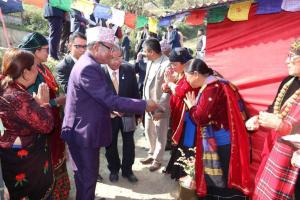 a man shaking hands with a group of people at Khasre Gurung Gaun Homestay in Nagarkot