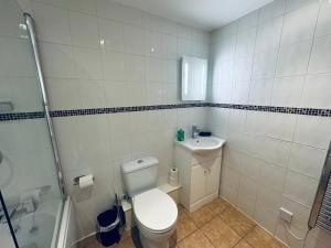 a bathroom with a toilet and a sink and a shower at Pears Suite - 1 Bedroom - Sleeps 2 in Whitehaven +56 photos