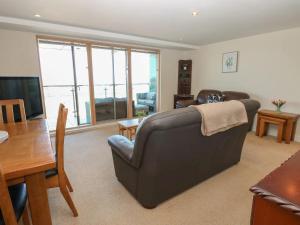 a living room with a couch and a table at Pears Suite - 1 Bedroom - Sleeps 2 in Whitehaven