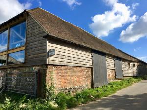 an old brick building on the side of a road at Norwood Barn in Maidstone