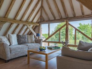 a living room with two couches and a table at Norwood Barn in Maidstone +19 photos