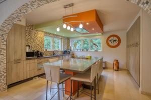a kitchen with a table and chairs in a room at Villa La Chauve Souris in Houffalize
