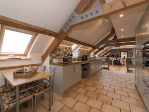 a kitchen with a vaulted ceiling with wooden beams at Y Beudy in Efenechtyd +42 photos