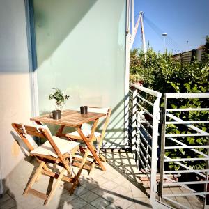 a wooden table and chairs on a balcony at Residenza stadio in Turin