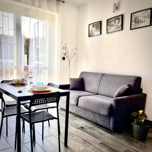 a living room with a couch and a table at Residenza stadio in Turin