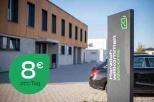 a sign in front of a car parked in front of a building at RELAXANS Hotel in Dinkelsbühl