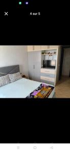 a picture of a bedroom with a bed and a kitchen at apartment for rent by the day in Agadir
