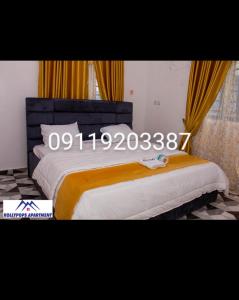 a bedroom with a large bed with aniversary at KOLLYPOPS Apartments in Otta