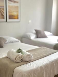 a room with two beds with towels on them at Unbeatable location in Medellín in Medellín +33 photos