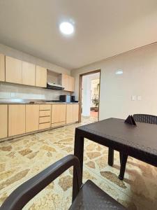a large kitchen with a table and a dining room at Unbeatable location in Medellín in Medellín