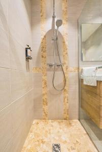 a bathroom with a shower with a glass door at Hôtel BO & MIA in La Baule +64 photos