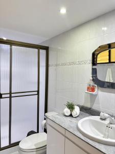 a bathroom with a toilet and a sink at Unbeatable location in Medellín in Medellín