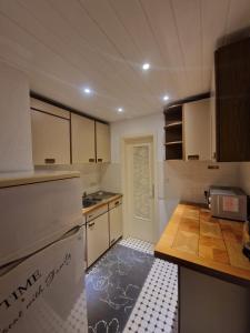 a kitchen with white cabinets and a counter top at Ferienwohnung-La Casa in Heidenheim +9 photos