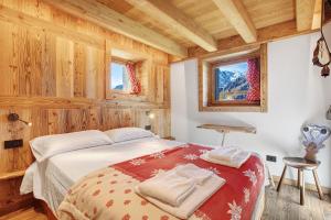 a bedroom with a bed in a room with wooden walls at Casa Promindoz in Valtournenche