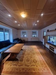 a living room with a couch and a table at Ferienwohnung-La Casa in Heidenheim