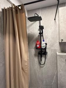 a shower with a curtain in a bathroom at Flat In the heart of Kaunas city center in Kaunas