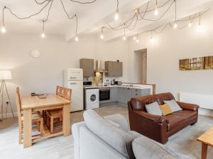 a living room with a couch and a table at The Barn-Uk32860 in Alltwen