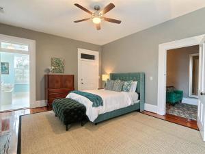 a bedroom with a bed and a ceiling fan at Mint Julep Estate in Savannah +48 photos