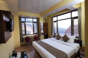 a bedroom with a large bed and two windows at Harmony Sentiments in Shimla +50 photos