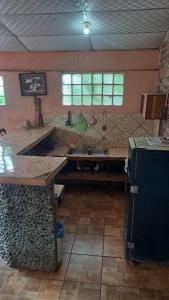 a kitchen with a sink and a counter top at la chiponga beach hostel in Altagracia
