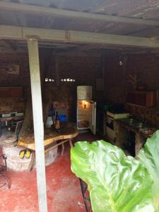 a large room with a room with a table and a refrigerator at la chiponga beach hostel in Altagracia