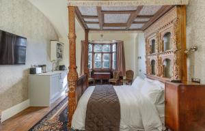 a bedroom with a bed with a wooden frame at East Dene Estate in Ventnor +91 photos
