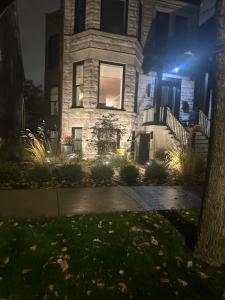 a house with lights on the front of it at night at The Lyons' Lair in Chicago