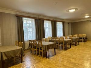 a conference room with tables and chairs and windows at Argishti Hotel in Vanadzor