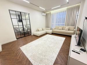 a living room with white furniture and a large rug at 4х комнатная Премиум класс возле Хан шатыра in Astana +16 photos