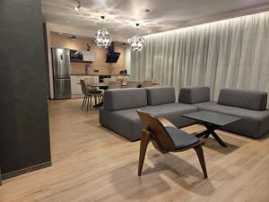 a living room with a couch and a table at Svečių namas in Radailiai