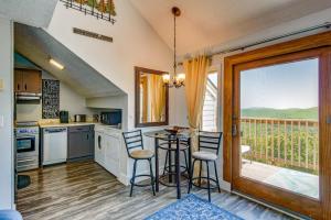 a kitchen with a table and chairs and a balcony at Top Of Seven in Seven Devils +57 photos