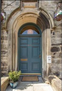 a blue door of a building with an arch at Bruce on the Row-Historic Elegance near Edinburgh in Dunfermline