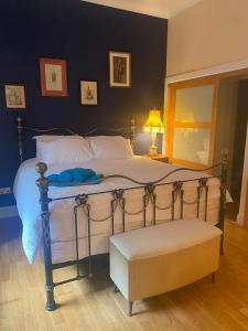 a bedroom with a bed with a mirror and a chair at Bruce on the Row-Historic Elegance near Edinburgh in Dunfermline +21 photos
