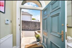 a blue door with a view of a courtyard at Bruce on the Row-Historic Elegance near Edinburgh in Dunfermline